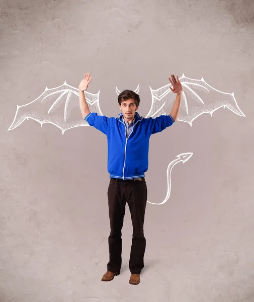 Young man with devil horns and wings drawing — Stock Photo, Image