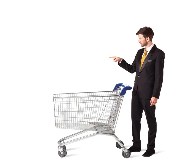 Businessman with shopping cart — Stock Photo, Image