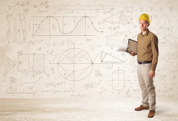 Ingeniero guapo calculando con fondo dibujado a mano — Foto de Stock