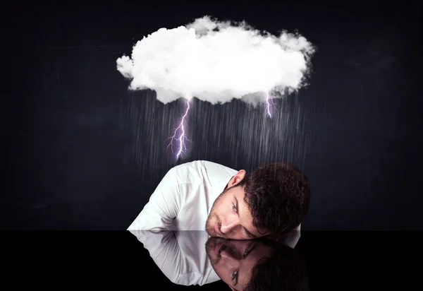 Depressed businessman sitting under a cloud — Stock Photo, Image