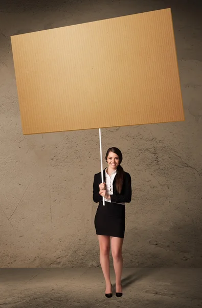 Businesswoman with blank cardboard — Stock Photo, Image