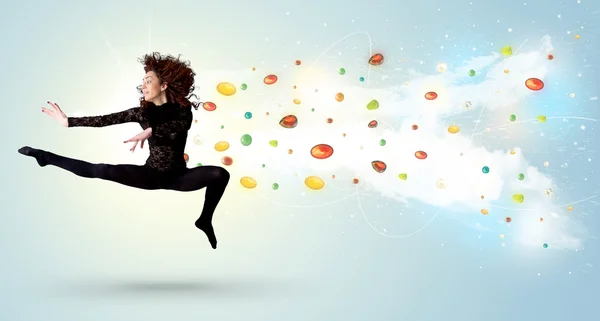 Beautiful woman jumping with colorful gems and crystals on the b — Stock Photo, Image