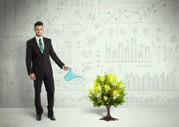 Business man pouring water on lightbulb growing tree — Stock Photo, Image