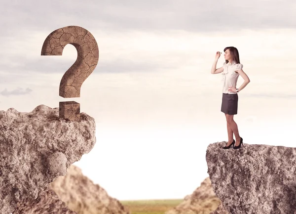 Businesswoman on rock mountain with a question mark — Stock Photo, Image