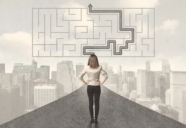 Business woman looking at road with maze and solution — Stock Photo, Image