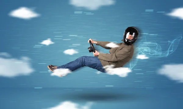 Funny racedriver young man driving between clouds concept — Stock Photo, Image