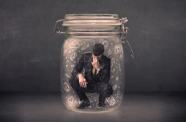 Business man captured in glass jar with hand drawn media icons c — Stock Photo, Image