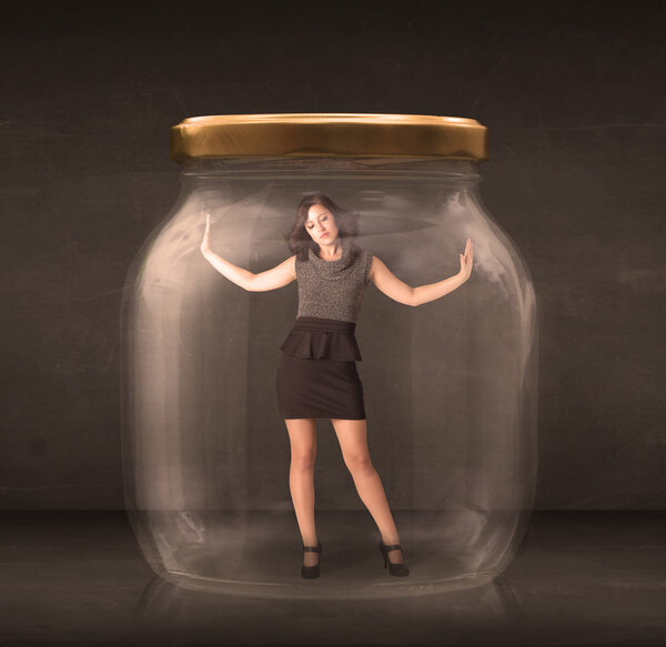 Businesswoman captured in a glass jar concept