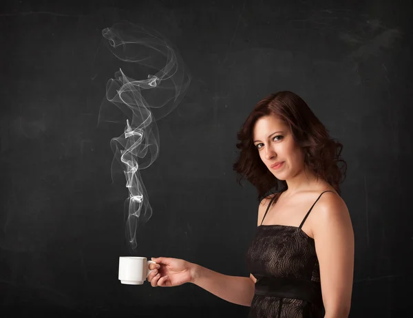 Businesswoman holding a white steamy cup — Stock Photo, Image