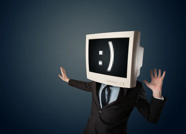 Divertente giovane uomo d'affari con un monitor sulla testa e smiley su — Foto Stock