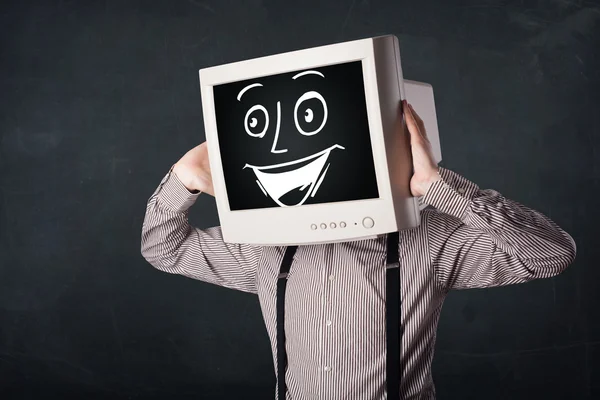 Glad affärsman med en PC monitor huvud och en smiley ansikte — Stockfoto