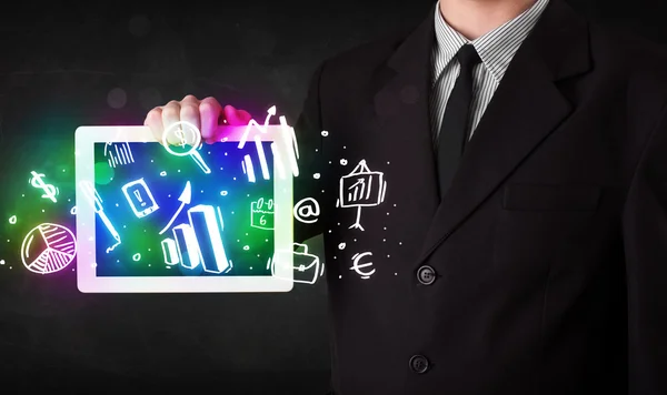 Young person holding tablet with graph and chart symbols — Stock Photo, Image