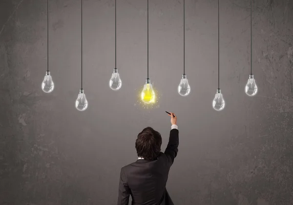 Businness guy in front of idea light bulbs concept — Stock Photo, Image