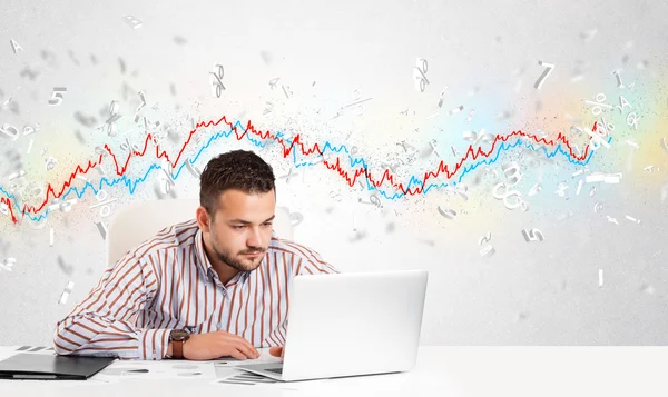 Business man sitting at table with stock market graph — Stock Photo, Image