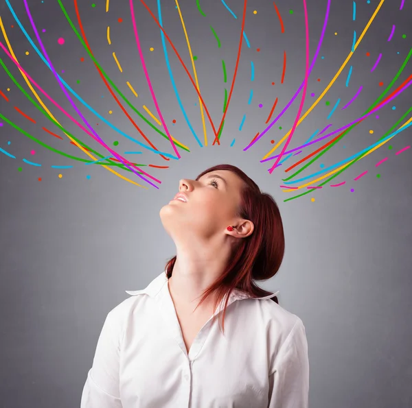 Young girl thinking with colorful abstract lines overhead — Stock Photo, Image