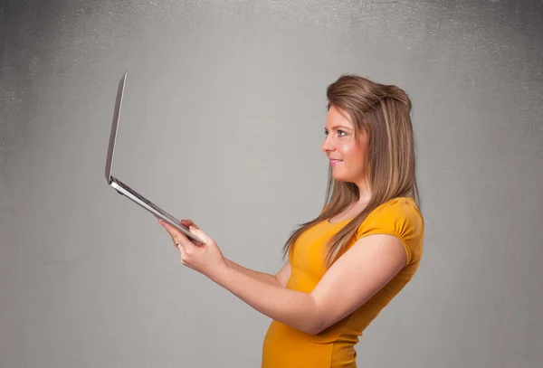 Young woman holding modern laptot — Stock Photo, Image