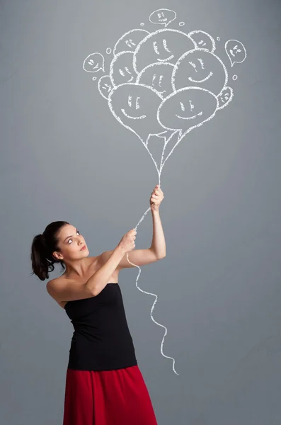 Mulher feliz segurando sorrindo balões desenho — Fotografia de Stock