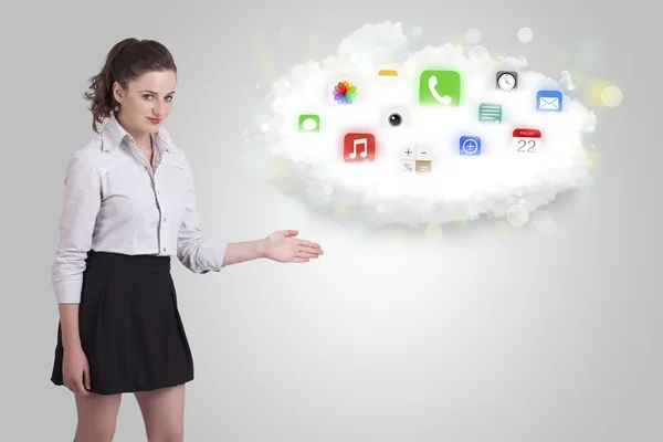 Young woman presenting cloud with colorful app icons and symbols — Stock Photo, Image