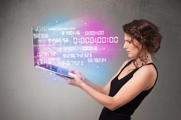 Casual woman holding laptop with exploding data and numers — Stock Photo, Image