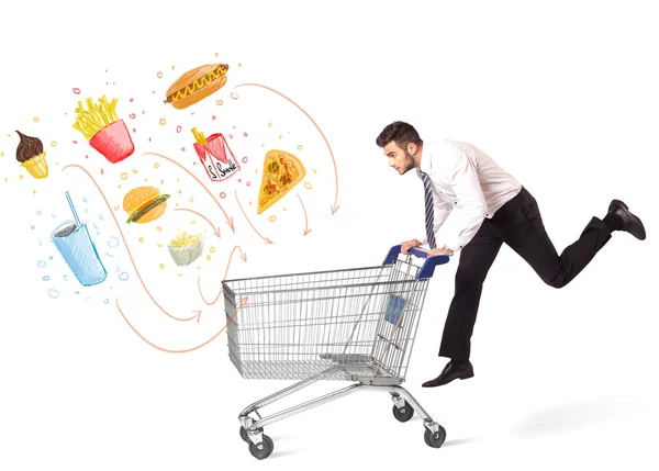 Man with shopping cart with toxic junk food — Stock Photo, Image