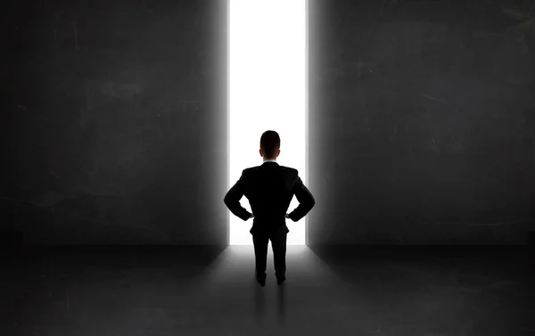 Persona de negocios mirando a la pared con apertura de túnel de luz —  Fotos de Stock