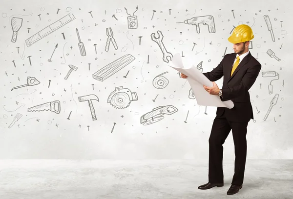 Construction worker planing with hand drawn tool icons — Stock Photo, Image