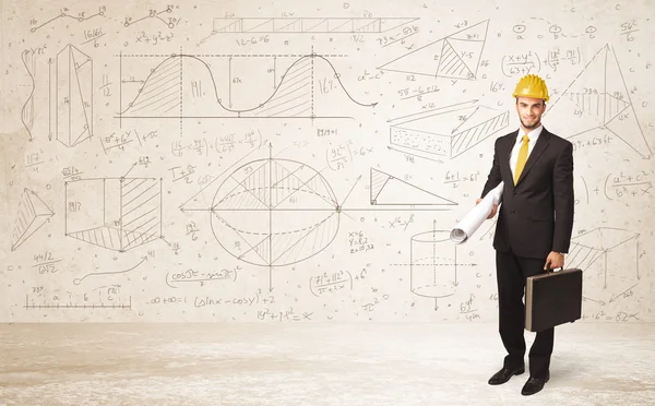 Handsome engineer calculating with hand drawn background — Stock Photo, Image