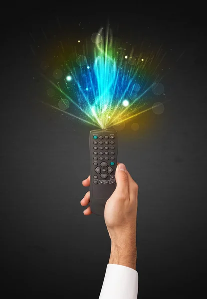 Hand with remote control and explosive signal — Stock Photo, Image