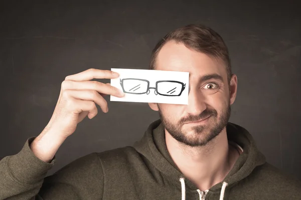 Happy guy looking with paper hand drawn eye glasses — Stock Photo, Image