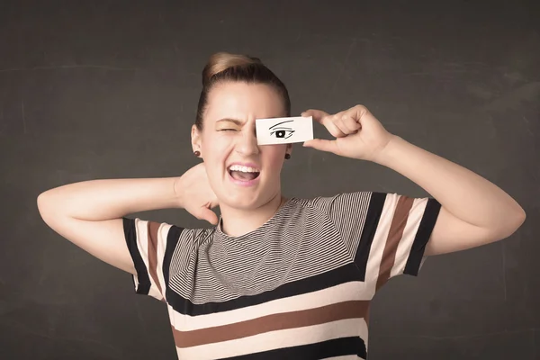 Silly youngster looking with hand drawn eye paper — Stock Photo, Image