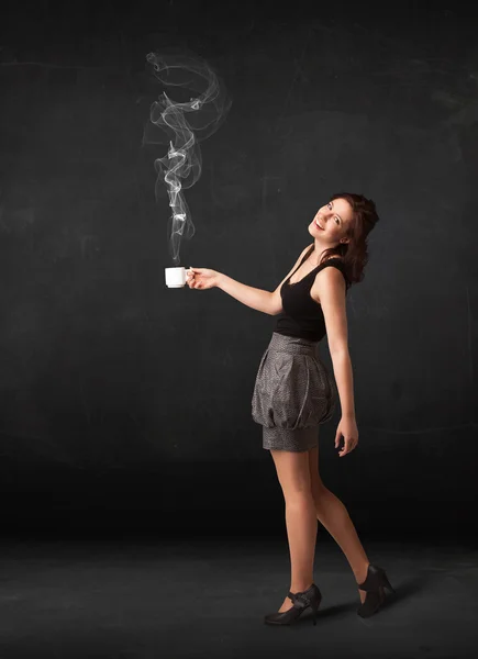 Businesswoman holding a white steamy cup — Stock Photo, Image