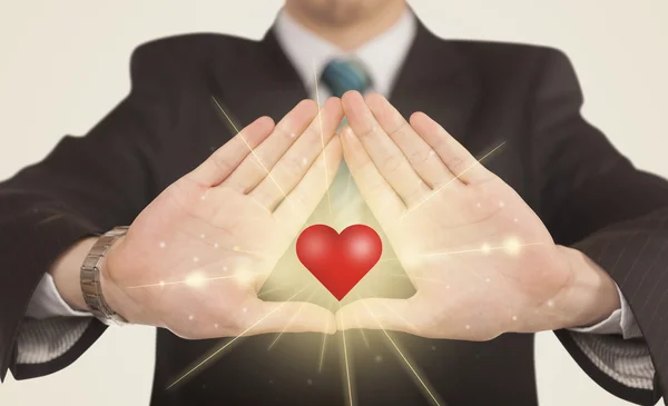 Hands creating a form with shining heart — Stock Photo, Image