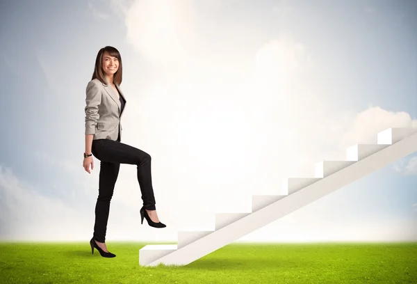 Business person climbing up on white staircase in nature Stock Picture
