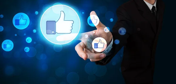 Handsome person pressing thumbs up button on modern social netwo — Stock Photo, Image