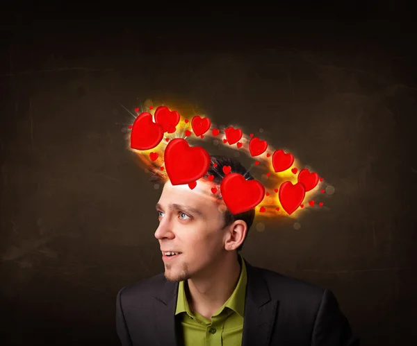 Young man with heart illustrations circleing around his head — Stock Photo, Image