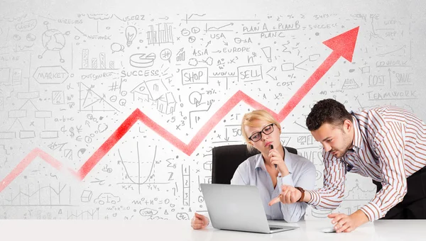 Hombre y mujer de negocios sentados a la mesa con diagramas de mercado — Foto de Stock