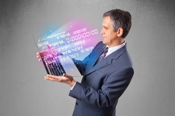 Businessman holding notebook with exploding data and numbers — Stock Photo, Image