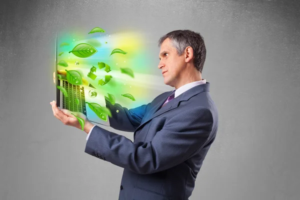 Businessman holding laptop with recycle and environmental symbo — Stock Photo, Image