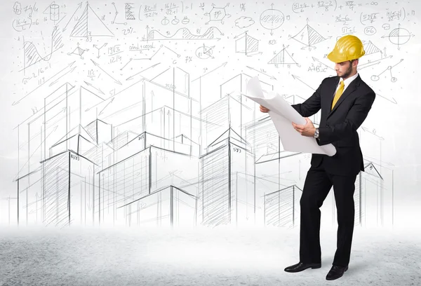 Handsome construction specialist with city drawing in background — Stock Photo, Image