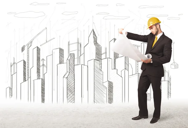 Engineer man with building city drawing in background — Stock Photo, Image