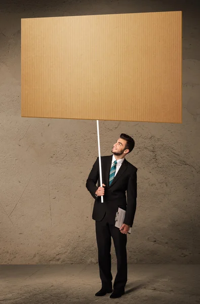 Businessman with blank cardboard — Stock Photo, Image