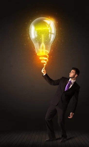 Businessman with an idea bulb — Stock Photo, Image