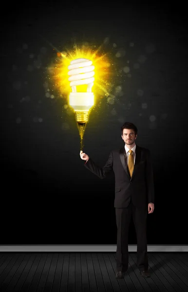 Businessman with an eco-friendly bulb — Stock Photo, Image