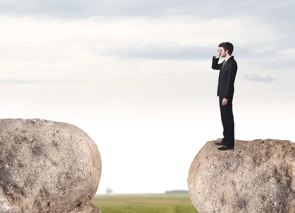 Businessman on rock mountain — Stock Photo, Image