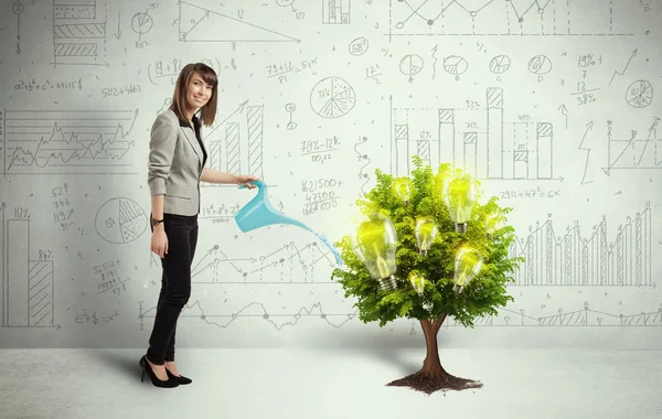 Business woman pouring water on lightbulb growing tree — Stock Photo, Image
