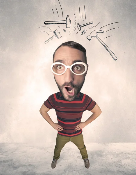 Big head person with drawn hammers — Stock Photo, Image