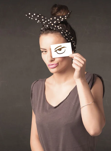 Young person holding paper with angry eye drawing — Stock Photo, Image