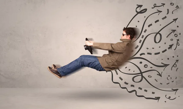 Funny man driving a flying vehicle with hand drawn lines after h — Stock Photo, Image