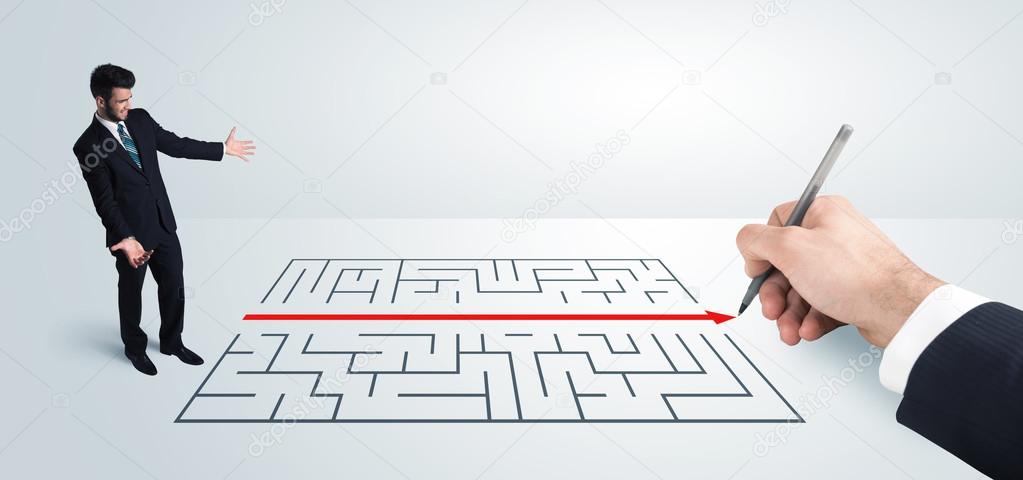 Business man looking at hand drawing solution for maze 