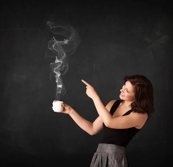Businesswoman holding a white steamy cup — Stock Photo, Image
